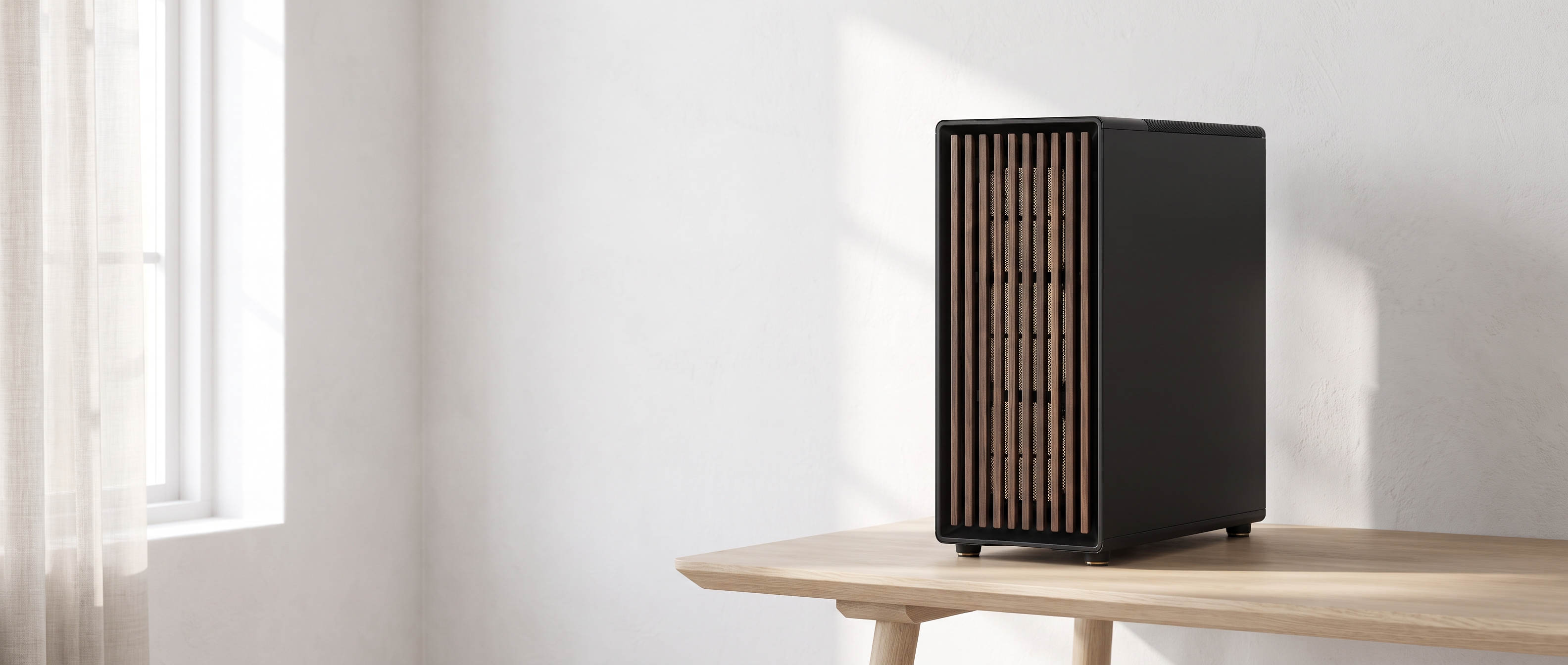 Fractal North workstation tower on an oak desk in a bright Scandinavian studio